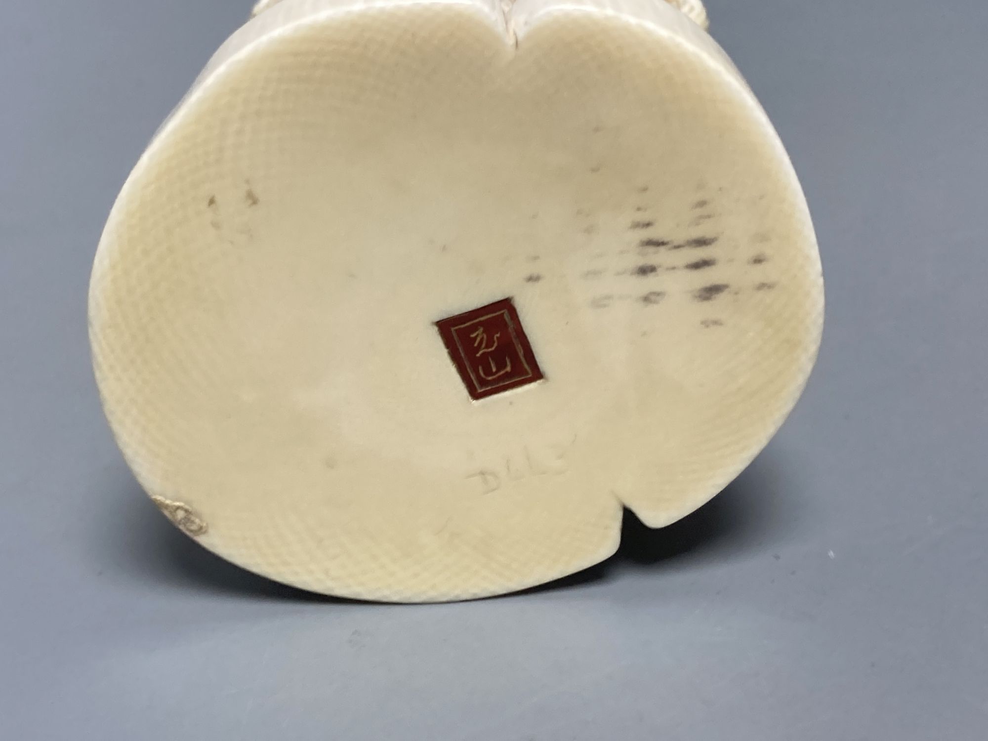 A Japanese ivory okimono of a man and dog, signed tablet to base, early 20th century, 19cm